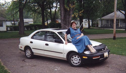 Elderly Couple Poses for Photo After Car Flips